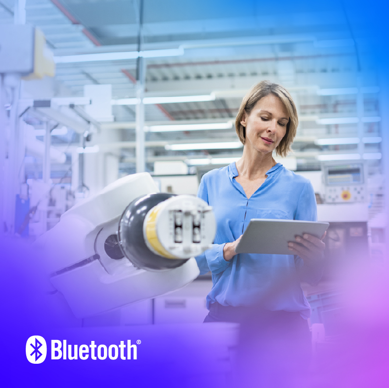 Focused woman in a robotics lab collaborates with advanced automation technology for enhanced productivity.